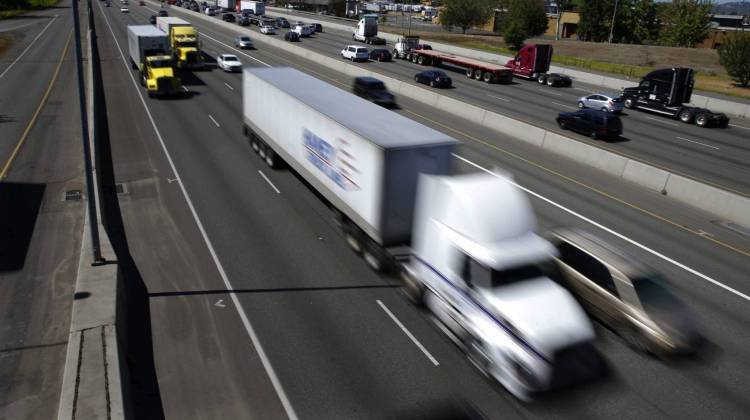 Truck and automobile traffic mix on Interstate 5, headed north through Fife, Wash., in August 2016. (Ted S. Warren/AP)