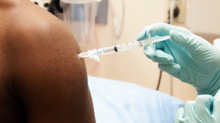 A man enrolled in a clinical trial receives a dose of the investigational NIAID/GlaxoSmithKline Ebola vaccine in 2014.  - Photo courtesy of the National Institute of Allergy and Infectious Diseases