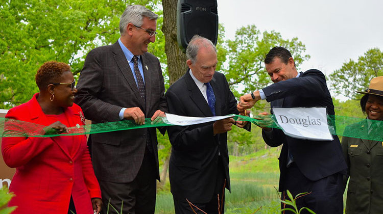 Gary Mayor Karen Freeman-Wilson, Gov. Eric Holcomb, U.S. Rep. Pete Visclosky (D-Merrillville), and U.S. Sen. Todd Young (R-Ind.) cut a ceremonial ribbon at the Indiana Dunes National Park. - Justin Hicks/IPB News