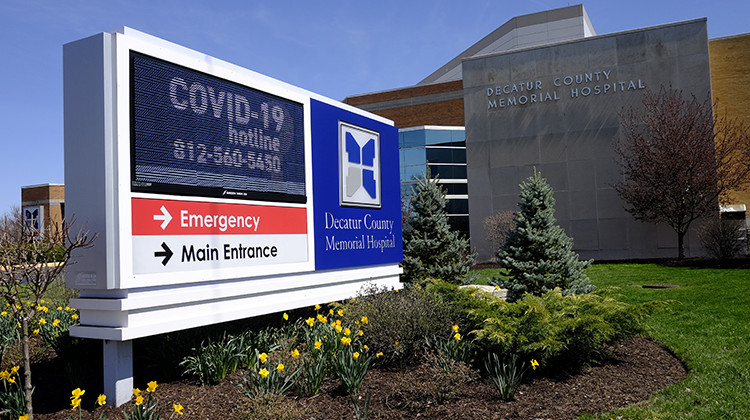 A COVID-19 hot line number is posted outside of Decatur County Memorial Hospital, Thursday, April 2, 2020, in Greensburg, Ind. Three southeast Indiana counties have among the highest per-capita coronavirus infection rates in the country.  - AP Photo/Darron Cummings