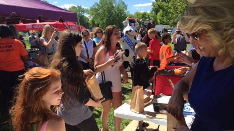 Kids receive food at a  federal summer food program in Indianapolis.