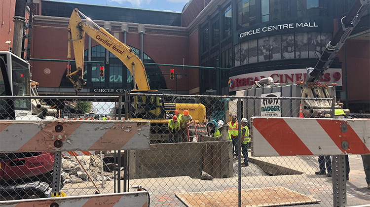 A construction crew works to repair a manhole structure collapse at the intersection of Maryland and Illinois streets. - Sarah Panfil/WFYI