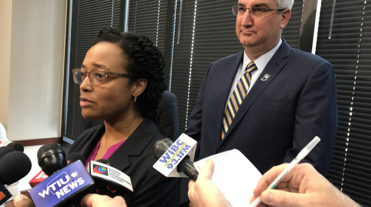 DCS Director Terry Stigdon and Gov. Eric Holcomb talk with the media after the release of an independent report on the agency in June 2018.  - (Brandon Smith/IPB News)