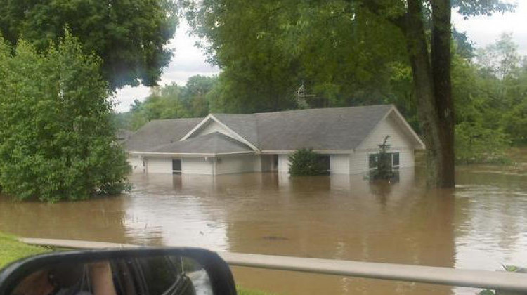 A home half underwater during the 2008 flood in Johnson County. Prince's Lake dam breached during the flood, making the problem worse. - (User:Me/Wikimedia Commons)