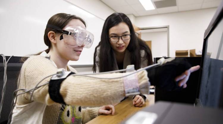 Indiana University graduate student Di Wu observes a test subject. - Photo courtesy of James Brosher/Indiana University