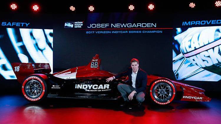 Josef Newgarden, 2017 Verizon IndyCar Series champion, describes the advantages of the new race car setup during the North American International Auto Show, Tuesday, Jan. 16, 2018, in Detroit. - AP Photo/Carlos Osorio