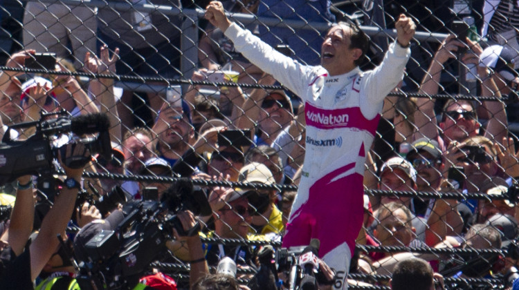Helio Castroneves celebrates his record-tying fourth Indianapolis 500 victory. Fans were allowed to attend the 2021 race, but capacity was limited due to the pandemic. - Doug Jaggers/WFYI