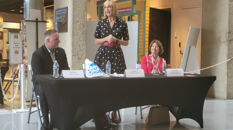 Lt. Gov. Suzanne Crouch speaks to Northwest Indiana tourism professionals, while South Shore CVA President/CEO David Uran and Indiana Destination Development Corporation Secretary and CEO Elaine Bedel listen, at the Indiana Welcome Center on July 26 - Michael Gallenberger / Lakeshore Public Media