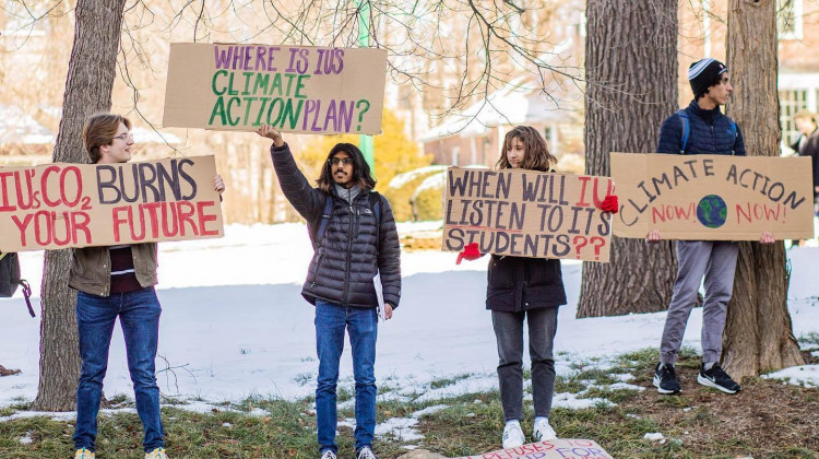 Students for a New Green World hold up signs at Indiana University asking the university to make a climate action plan. - (McKenna Conway/Students for a New Green World)