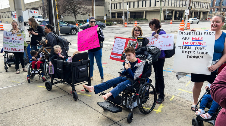 A parent protesting at the event said she doesn’t understand why the governor can make time for an event to celebrate legalizing happy hours, but can’t find time to respond to families about the “attendant care crisis.”  - Brandon Smith/IPB News