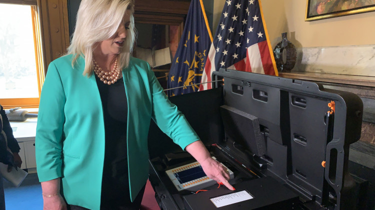 Indiana Secretary of State Holli Sullivan demonstrates how "voter verifiable paper audit trails" work with electronic voting machines. - Brandon Smith/IPB News
