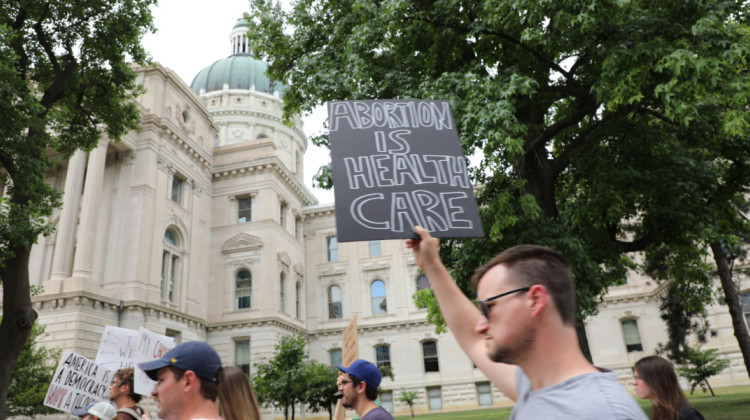 Protestors holding signs during a 2022 rally opposing a bill to ban abortions. - Eric Weddle/WFYI