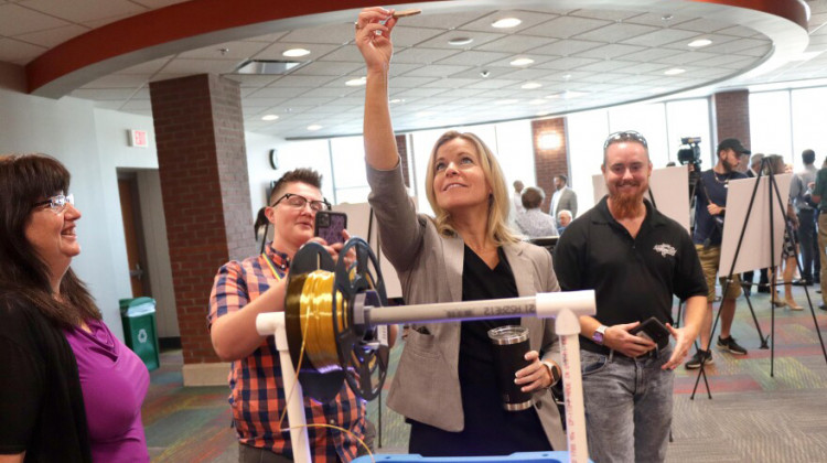 Celia Shoulders holds aloft a 3D printed image of Ivy tech innovation center namesake Thomas Boeglin Tuesday at Ivy tech Community College in Evansville.  - Tim Jagielo/WNIN