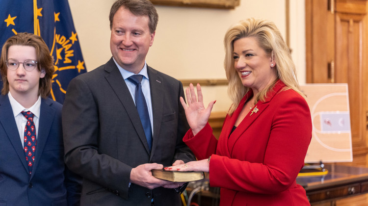 Former Rep. Holli Sullivan is sworn in as Indiana Secretary of State alongside her husband and son.  - Courtesy of the governor's office