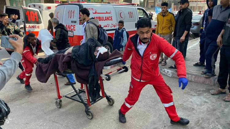 Workers rush injured people to Mohammed Yousef al-Najjar Hospital in Rafah as Israel resumed its bombing Friday morning in the Gaza Strip. - Anas Baba/NPR