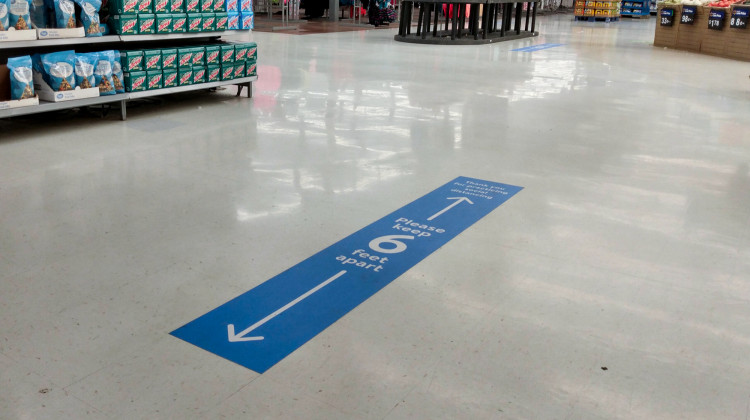 Stickers on the floor of a Walmart in Indianapolis, show how far apart customers should within the store.  - Lauren Chapman/IPB News