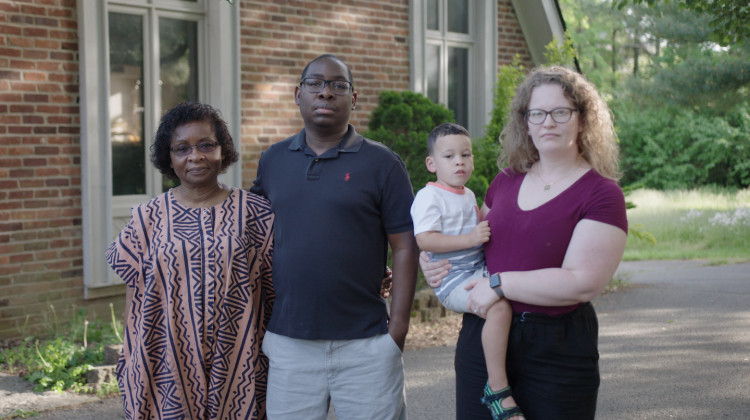 Paul Gakpo (second from the left) lives in Kentucky with his wife, Michelle (far right) and son, Louis. The family poses for a photo outside their home with Pauls mother, Philomena, in May. - Jacob Dean / Side Effects Public Media