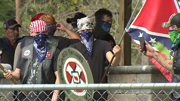 Police escorted KKK members to and from their gathering location, and most members covered their faces with bandanas and sunglasses. - Steve Burns/WFIU-WTIU News