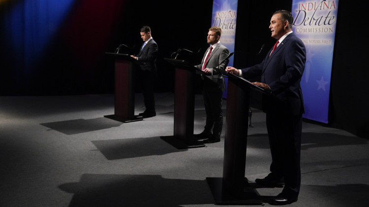 Democrat Thomas McDermott, right, speaks as Sen. Todd Young, left, and Libertarian James Sceniak listen, Sunday, Oct. 16, 2022, in Indianapolis. (AP Photo/Darron Cummings, Pool) - Darron Cummings/AP / AP