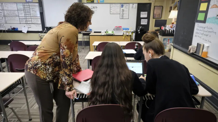 Students and a teacher at work in a classroom at Providence Cristo Rey High School in Indianapolis. A new Indiana law will automatically enroll more 8th graders into the 21st Century Scholars Program. But some wonder how they can access and maintain the scholarship. - Alan Petersime for Chalkbeat