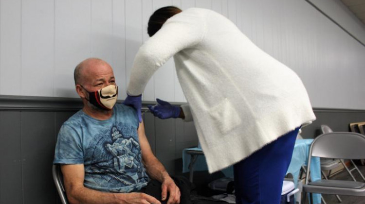 Jose Martinez, a resident of Cobden, Ill., gets the first dose of the coronavirus vaccine on Feb. 27 at a temporary vaccination clinic. - Christine Herman/Illinois Newsroom