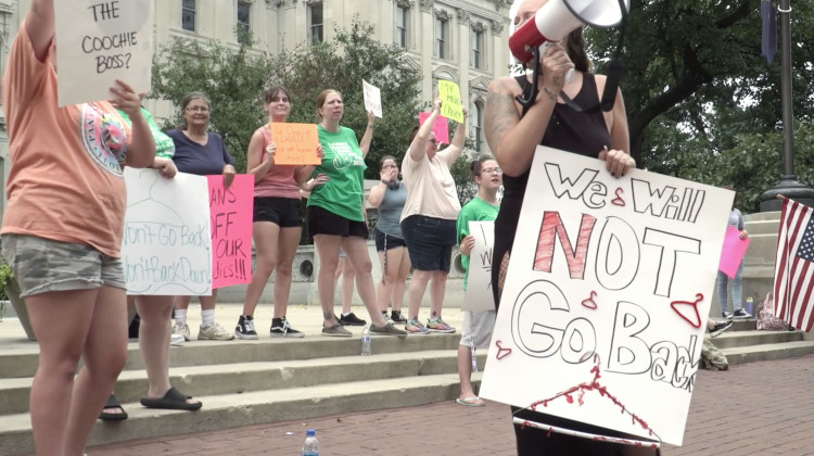 Protesters gathered at the Indiana Statehouse last year ahead of a special legislative session in which lawmakers passed a near-total abortion ban. The ban was temporarily halted after a challenge was heard by the Indiana Supreme Court. It takes effect Aug. 1.  - Alan Mbathi/IPB News