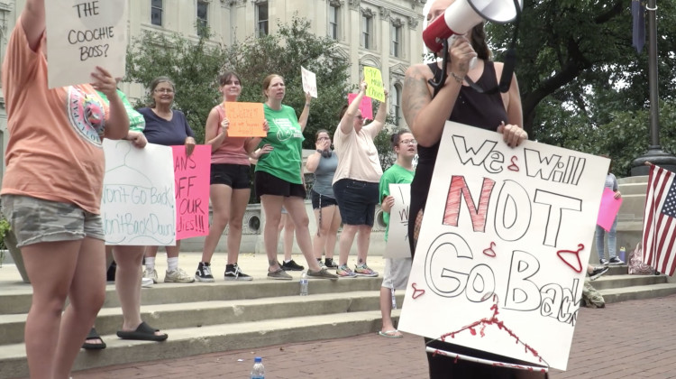 Protesters gathered at the Indiana Statehouse last year ahead of a special legislative session in which lawmakers passed a near-total abortion ban. The ban was temporarily halted after a challenge was heard by the Indiana Supreme Court. It takes effect Aug. 1. - Alan Mbathi/IPB News