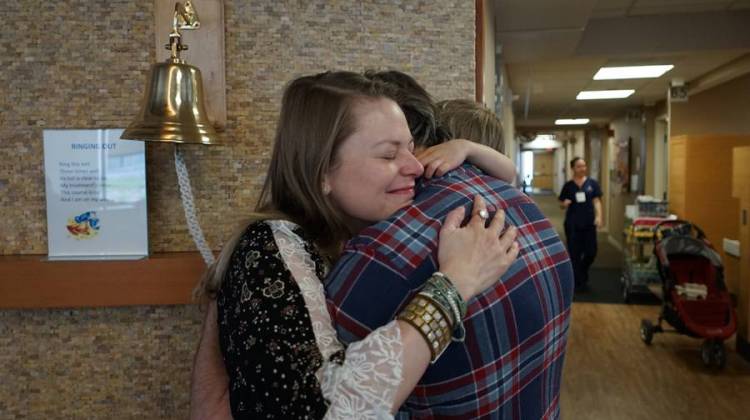 Carmen, Tom and Buck Breedlove embrace after Carmen's final chemotherapy infusion at the IU Health Simon Cancer Center. - Leigh DeNoon