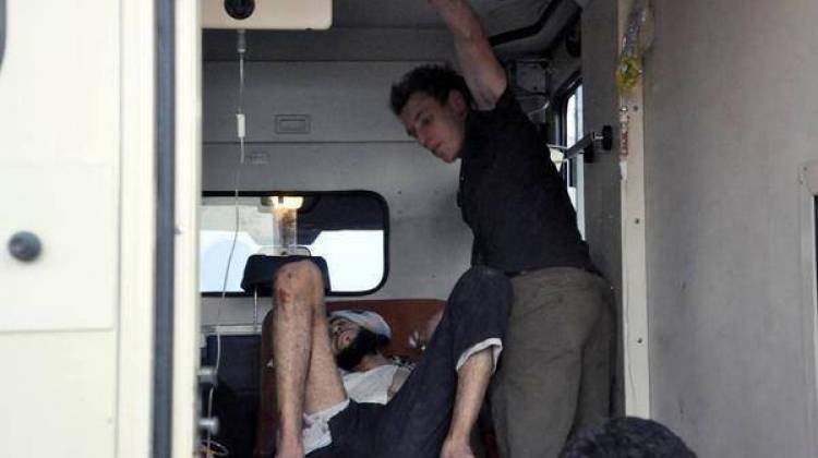 Abdul-Rahman Kassig working as an EMT to help a wounded man. A trained emergency medical technician, Kassig provided medical aid and first-aid training to those involved in the Syrian conflict in his work with Special Emergency Response and Assistance (SERA). Photo taken near Deir Ezzor in August 2013. - Photo provided to the Kassig family by the copyright owner with permission for media use.