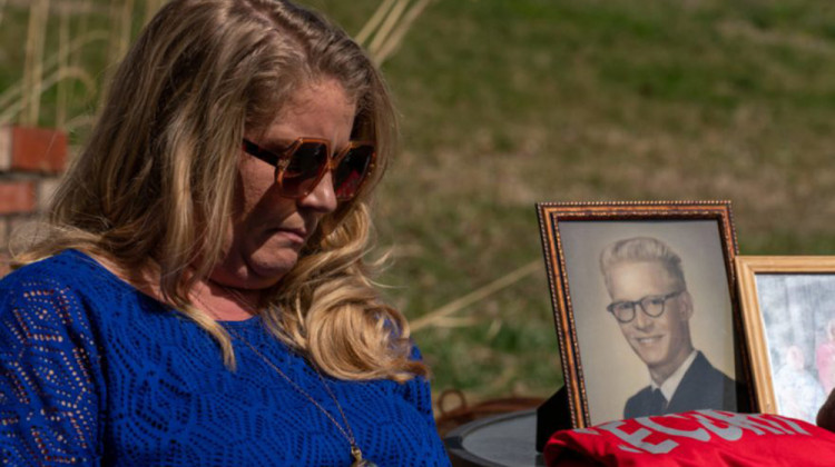 Angi Bostock with a photo of her father, Norbert "Nobby" Bostock, who died in the spring of 2020. - J. Tyler Franklin/WFPL