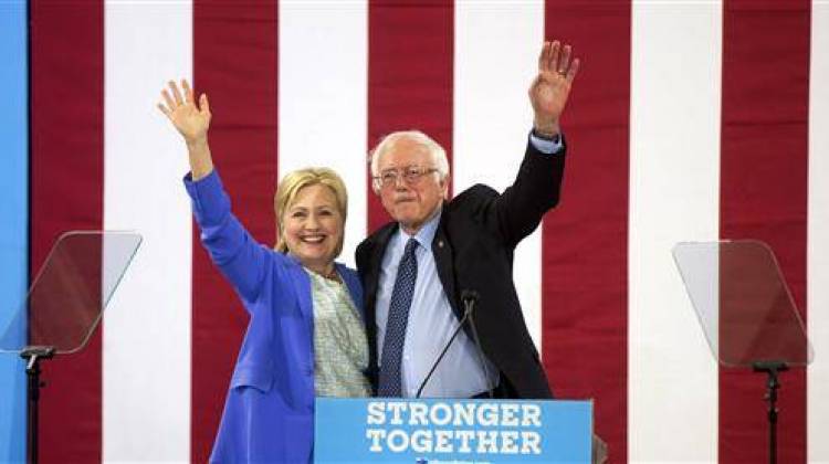 Democratic presidential candidate Hillary Clinton and Sen. Bernie Sanders, I-Vt., wave during a rally in Portsmouth, N.H., Tuesday, July 12, 2016, where Sanders endorsed her for president.. - AP Photo/Jim Cole
