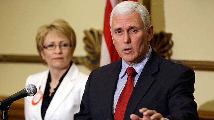 Indiana Gov. Mike Pence, right, talks about the state budget proposed by Senate Republicans as Lt. Gov. Sue Ellspermann looks on during a press conference on April 4, 2013.  - AP Photo/Michael Conroy
