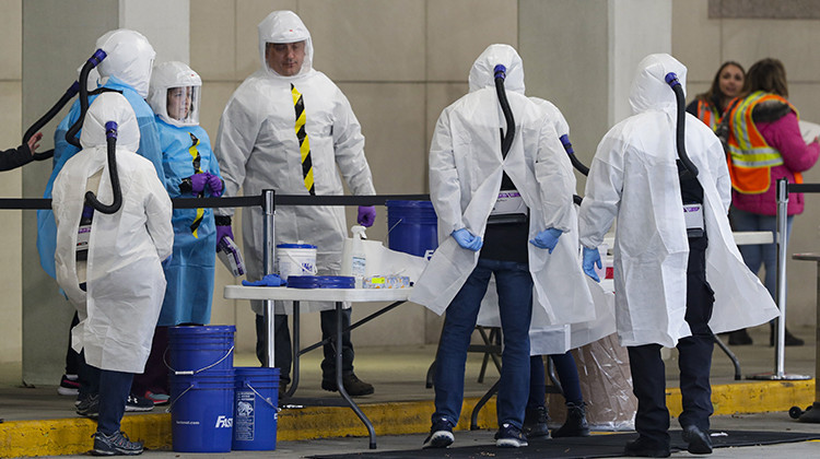 Employees of Eli Lilly prepare to start drive-through testing for COVID-19, the disease caused by the new coronavirus, to Indianapolis area healthcare workers at the company headquarters in Indianapolis, Monday, March 23, 2020. - AP Photo/Michael Conroy