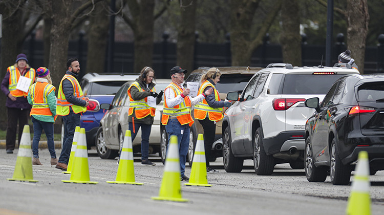 Employees of Eli Lilly check in members of the healthcare community as they begin drive-thru testing for COVID-19, the disease caused by the new coronavirus, at the company headquarters in Indianapolis, Monday, March 23, 2020. - AP Photo/Michael Conroy