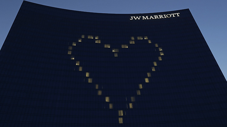 A heart shines on the side of the JW Marriott, Tuesday, April 7, 2020, in Indianapolis. The downtown hotel has suspended operations due to COVID-19. - AP Photo/Darron Cummings
