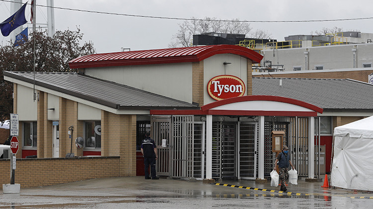 A Tyson Fresh Meats plant employee leaves the plant, Thursday, April 23, 2020, in Logansport, Indiana. The plant temporarily closed after several employees tested positive for COVID-19. - AP Photo/Darron Cummings