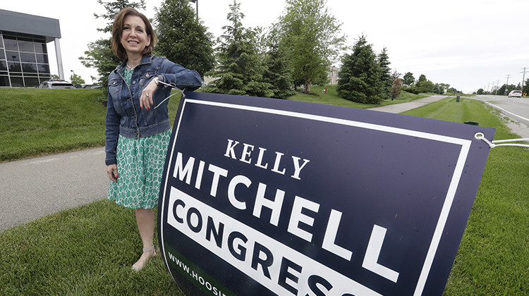 Indiana State Treasurer Kelly Mitchell stands by a campaign sign, Thursday, May 28, 2020, in Westfield, Ind. Mitchell is a candidate for Indiana's 5th Congressional District. More Republican women than ever are seeking House seats this year after the 2018 election further diminished their limited ranks in Congress. But so far it appears that any gains this November could be modest.  - AP Photo/Darron Cummings