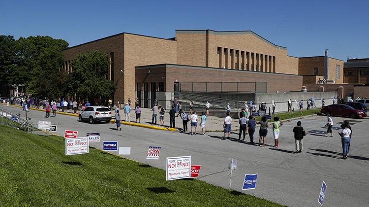 Voters wait in a line outside Broad Ripple High school to vote in the Indiana primary in Indianapolis, Tuesday, June 2, 2020 after coronavirus concerns prompted officials to delay the primary from its original May 5 date. Voters waited up to two hours to cast their ballots. Nearly 550,000 voters requested mail-in ballots, more than 10 times the number of those ballots cast during the 2016 primary.  - AP Photo/Michael Conroy