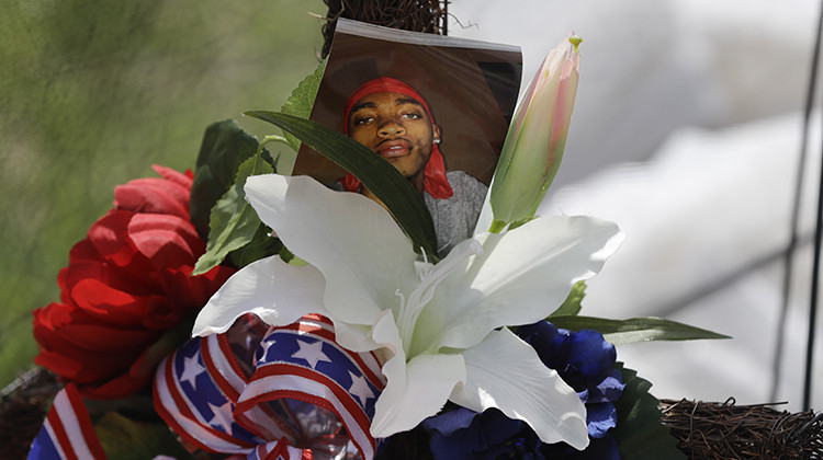 A photo of Dreasjon "Sean" Reed is placed in a memorial before a news conference, Wednesday, June 3, 2020, in Indianapolis. The family of Reed, a black man who was fatally shot by an Indianapolis police officer, called Wednesday for the federal government to intervene and conduct its own probe of his death. - AP Photo/Darron Cummings