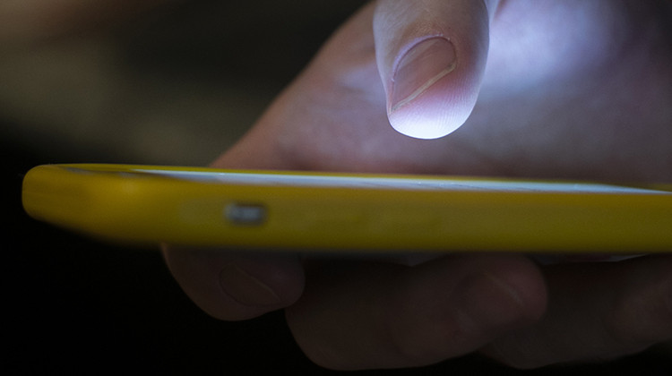 FILE - In this Aug. 11, 2019, file photo, a man uses a cell phone in New Orleans. The U.S. communications regulator on Tuesday, June 9, 2020, proposed a $225 million fine, its largest ever, against two health insurance telemarketers for spamming people with 1 billion robocalls using fake phone numbers.  - AP Photo/Jenny Kane, File