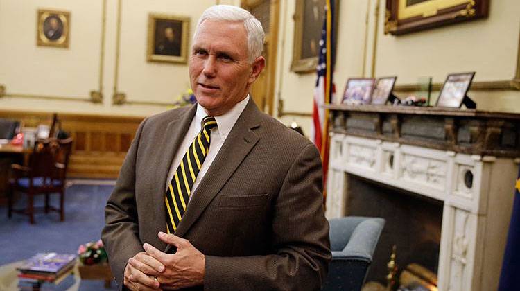 Then Gov. Mike Pence speaks after a meeting with Indianapolis Archbishop Joseph Tobin at the Statehouse Wednesday, Dec. 2, 2015, in Indianapolis, a day after the archdiocese said it has the means to resettle a Syrian refugee family bound for the state. - AP Photo/Darron Cummings