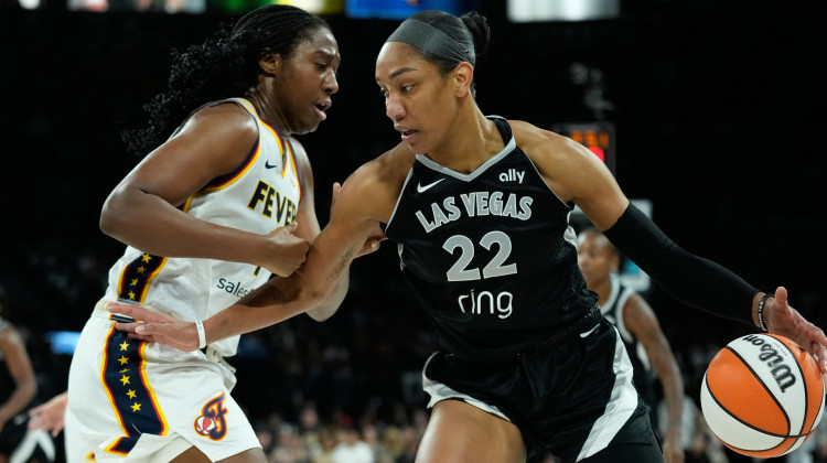 Las Vegas Aces center A'ja Wilson (22) drives against Indiana Fever forward Aliyah Boston (7) during the first half of Game 5 of a WNBA basketball playoff semifinals series Tuesday, Sept. 30, 2025, in Las Vegas. - John Locher / AP Photo