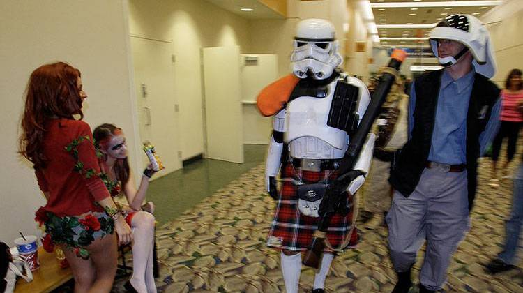 Chris Graburn and Mike Adams, right, walks past guests attending the Gen Con Convention, Aug. 5, 2010. - AP Photo/Darron Cummings