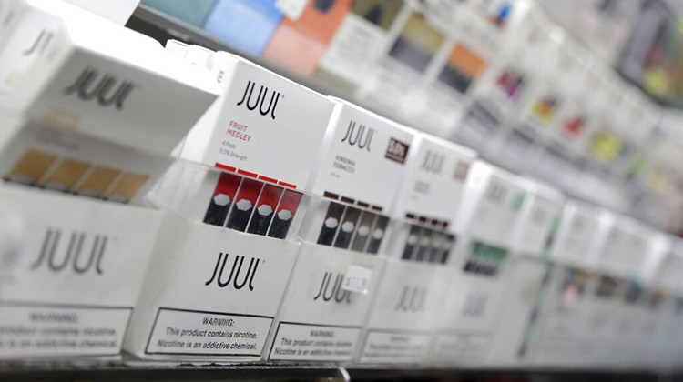 A bill signed into law this week includes provisions cutting the 25% tax that wholesalers were to be charged for closed-system vaping cartridges such as Juul devices to 15%. - AP Photo/Seth Wenig, File