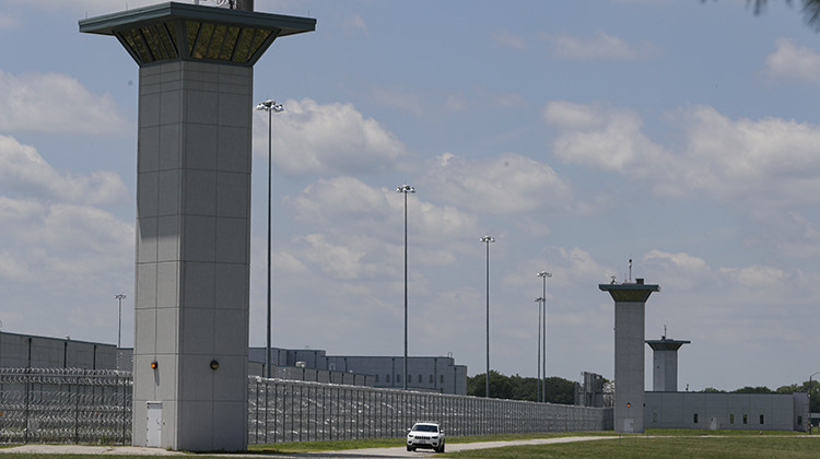 FILE - In this July 17, 2020 file photo the federal prison complex in Terre Haute, Ind., is shown. Anti-death penalty activists Tuesday, Aug. 4, 2020, asked a judge to order Indiana State Police to stop blocking roads to a prison where federal executions have resumed after a 17-year pause, arguing the roadblocks set up unconstitutional no-protest zones and impede protesters' free-speech rights.  - AP Photo/Michael Conroy, File