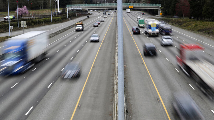 FILE - In this Monday, March 25, 2019, file photo, cars and trucks travel on Interstate 5 near Olympia, Wash. A new study says that safety features such as automatic emergency braking and forward collision warnings could prevent more than 40% of crashes in which semis rear-end other vehicles.  - AP Photo/Ted S. Warren, File