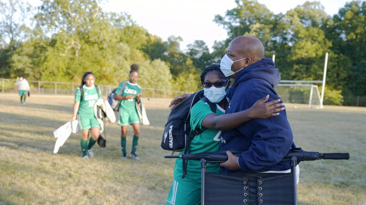 Larry Brown, hugs his daughter, Justys Glenn, right, following a soccer game, Wednesday, Sept. 30, 2020, in Indianapolis. Larry Brown spent about 80 days in an Indianapolis hospital this spring, fighting COVID-19 and nearly dying. His journey since returning home in June has been filled with unknowns. - AP Photo/Darron Cummings