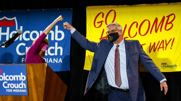 Indiana Gov. Eric Holcomb gets a high five from Lt. Gov. Suzanne Crouch after he addressed supporters after winning his second term as governor in Indianapolis, Tuesday, Nov. 3, 2020. - AP Photo/Michael Conroy