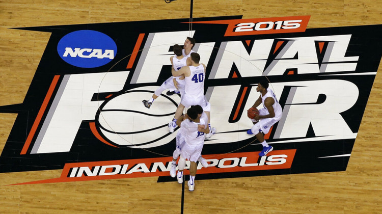 FILE - Duke players celebrate after the NCAA Final Four college basketball tournament championship game against Wisconsin in Indianapolis, in this Monday, April 6, 2015, file photo. The NCAA announced Monday, Nov. 16, 2020, it plans to hold the entire 2021 men’s college basketball tournament in one geographic location to mitigate the risks of COVID-19 and is in talks with Indianapolis to be the host city. - AP Photo/David J. Phillip, File
