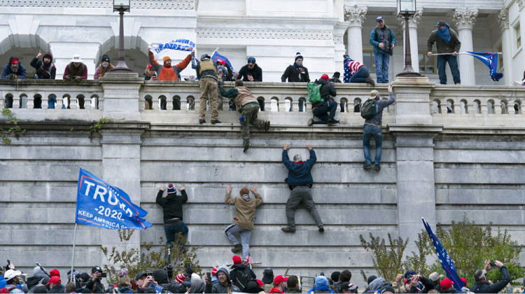 FILE - In this Wednesday, Jan. 6, 2021 file photo, supporters of President Donald Trump climb the west wall of the the U.S. Capitol in Washington. - AP Photo/Jose Luis Magana